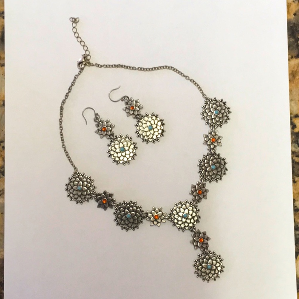 Silver necklace and earrings.